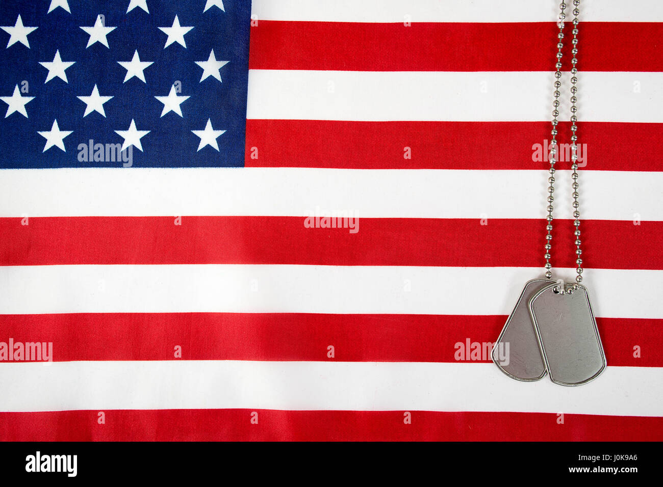 military dog tags on American flag Stock Photo - Alamy