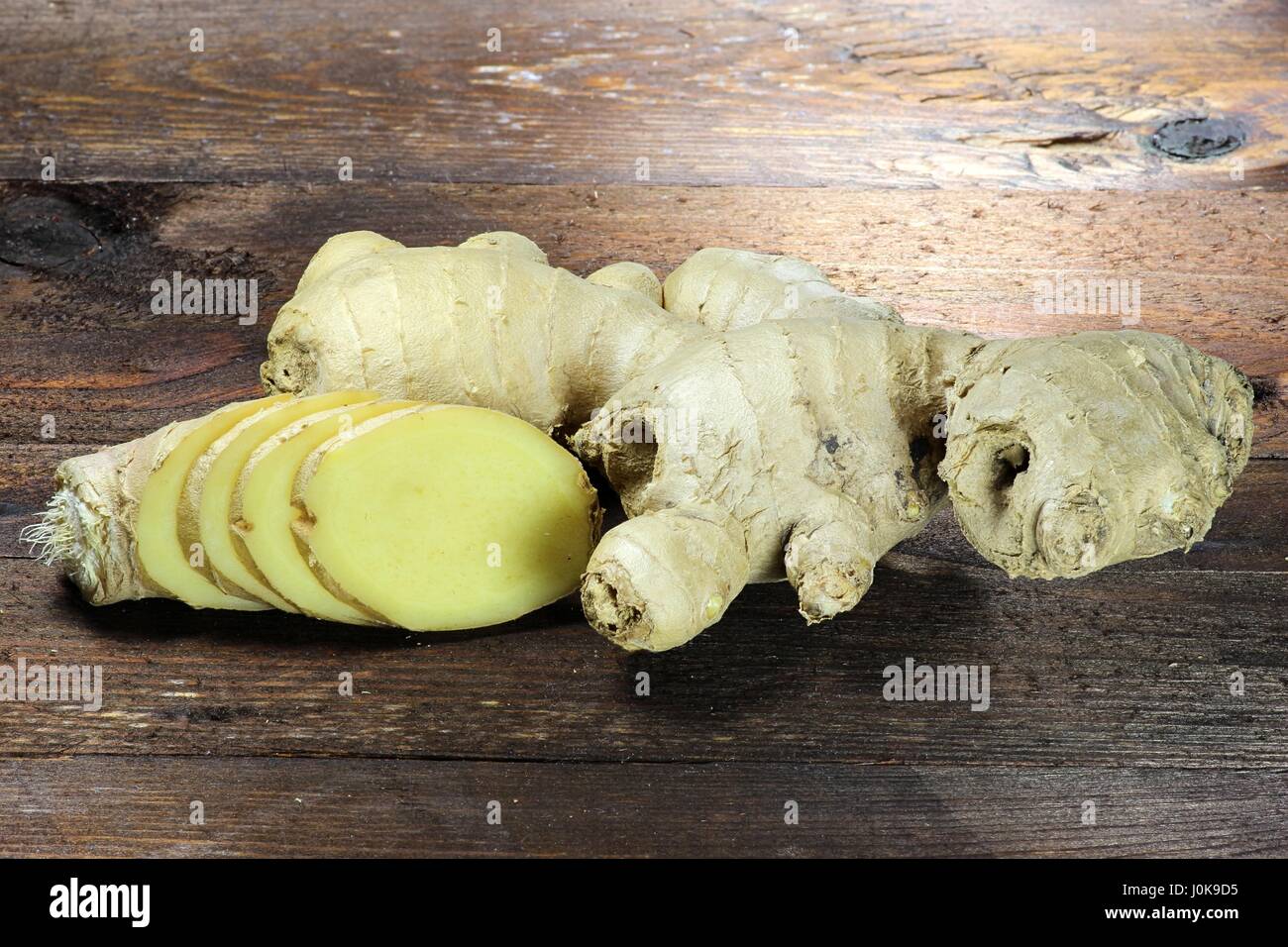 ginger rhizome on wooden background Stock Photo
