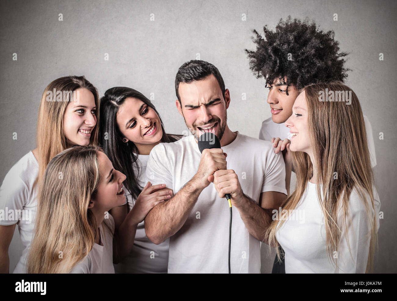 Friends doing karaoke together Stock Photo Alamy