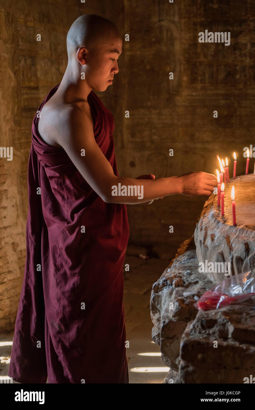 Lighting the candles before prayer Stock Photo Alamy
