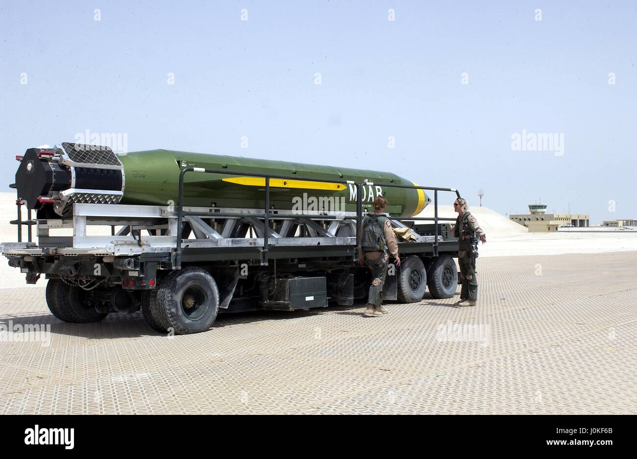 A U.S. Air Force Massive Ordnance Air Blast (MOAB) bomb sits on the flight line on a flatbed trailer for possible use during Operation Iraqi Freedom May 3, 2003 in Al Udeid Air Base, Qatar.  The MOAB is a precision-guided munition weighing 21,500 pounds and is the largest non-nuclear conventional weapon in existence. Stock Photo