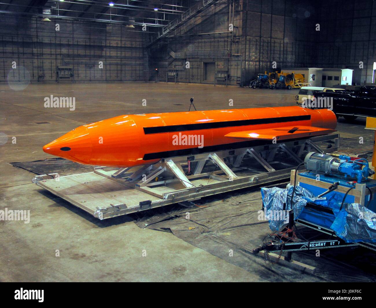 A U.S. Air Force Massive Ordnance Air Blast (MOAB) bomb is prepared for testing at the Eglin Air Force Armament Center March 11, 2003 in Valparaiso, Florida.  The MOAB is a precision-guided munition weighing 21,500 pounds and is the largest non-nuclear conventional weapon in existence. Stock Photo