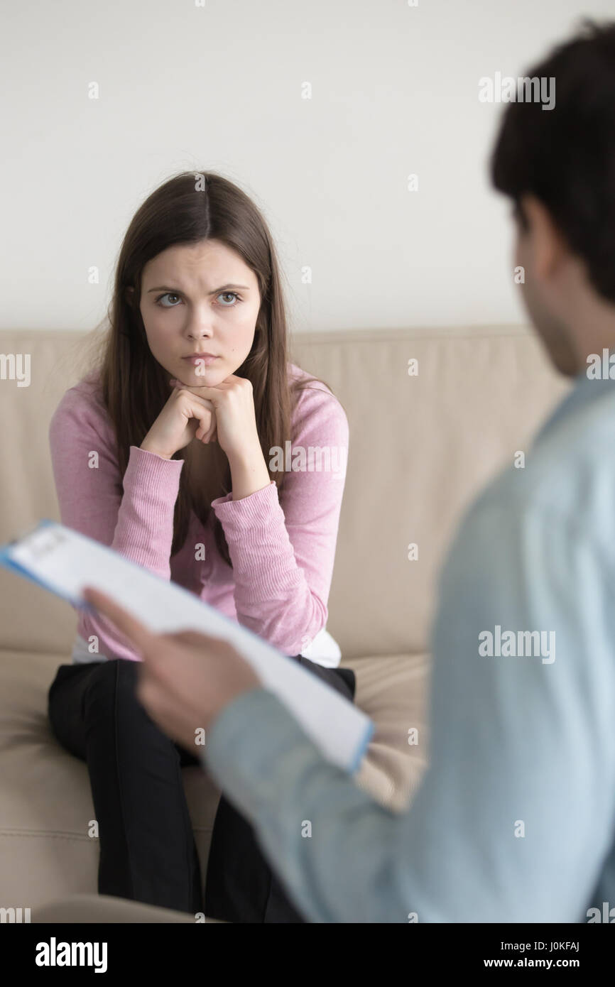 Young worried woman finding out diagnosis or medical test result Stock Photo