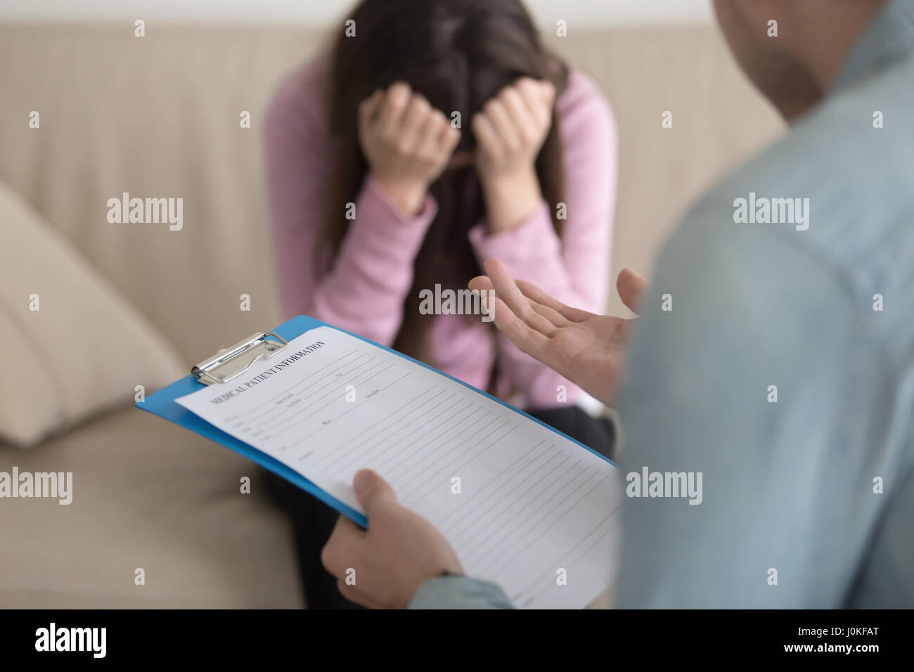 Psychologist start working with depressed female patient, holdin Stock Photo