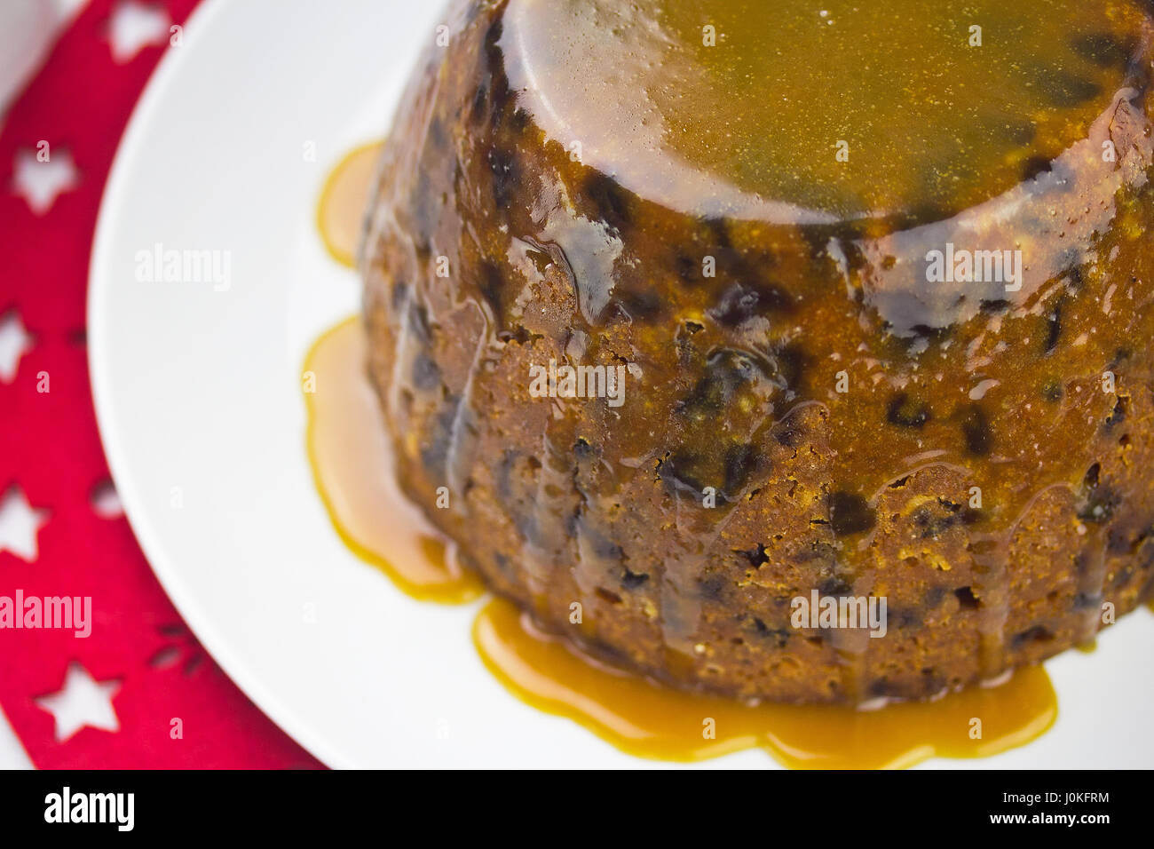 Christmas pudding with caramel sauce Stock Photo Alamy