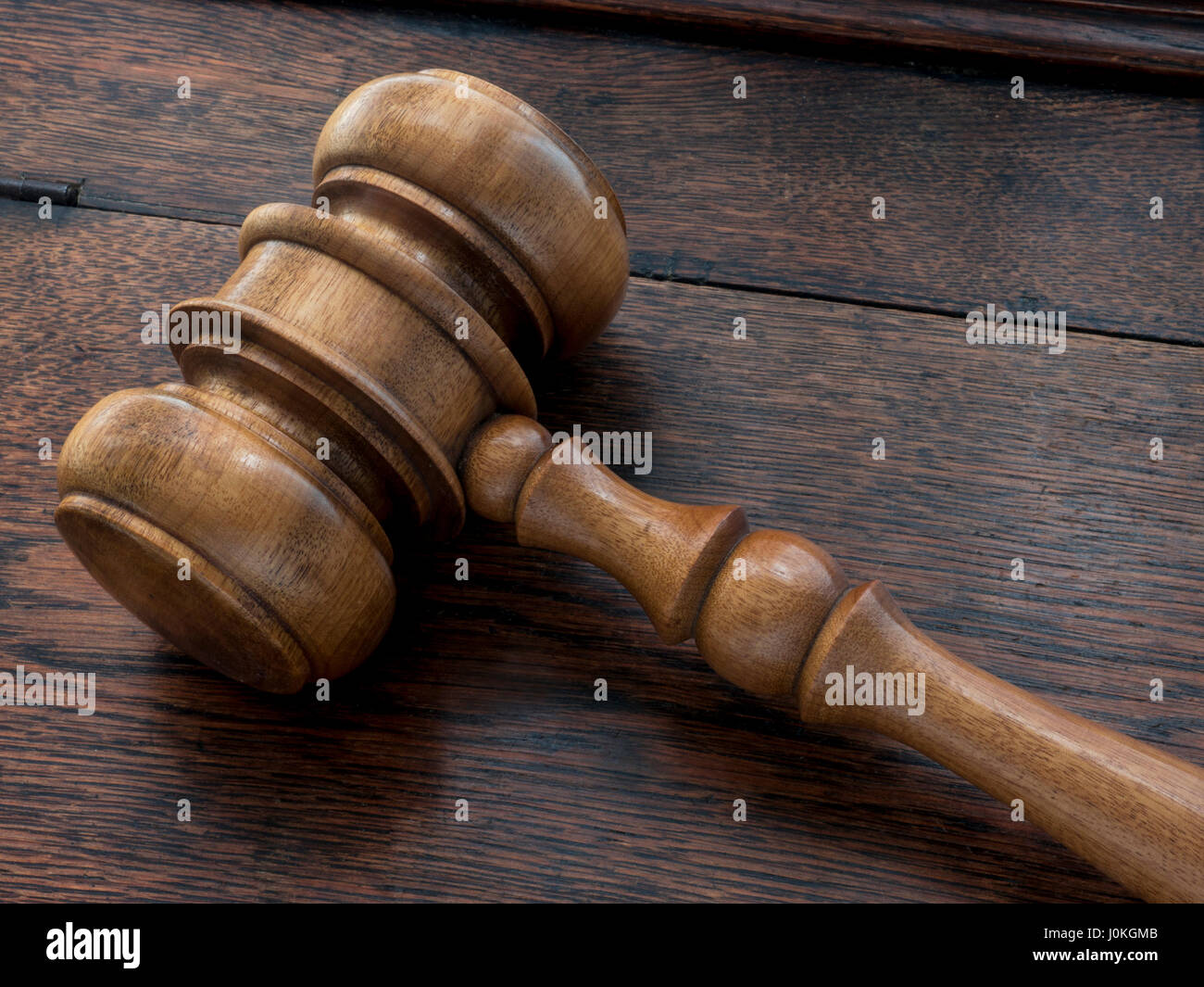 Auctioneer /Judges wooden gavel on old wooden desk top Stock Photo