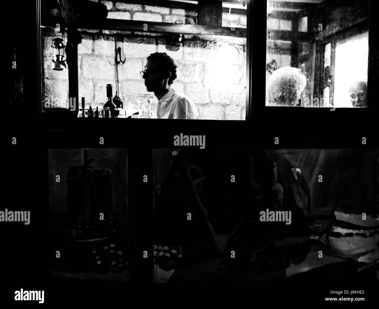 Young male sitting alone in a cafe, Croatia Stock Photo
