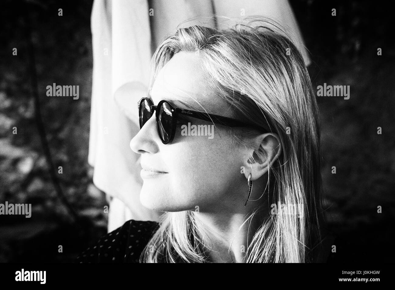 Young Woman in Sunglasses and earrings Stock Photo