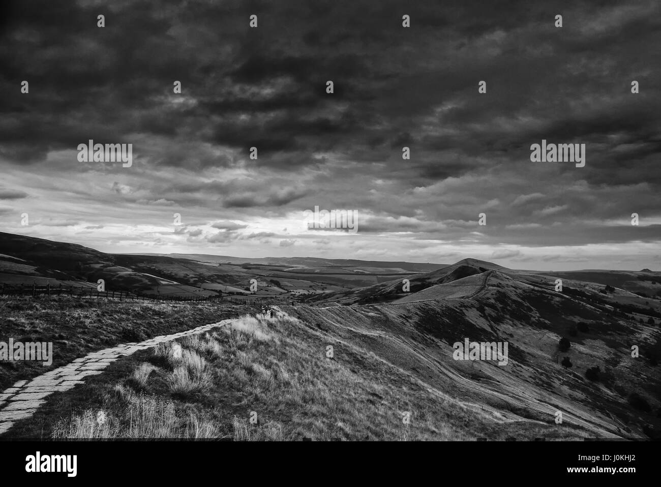 A stone path leading off into the distance on Mam Tor in winter.  Peak District, Derbyshire, England Stock Photo