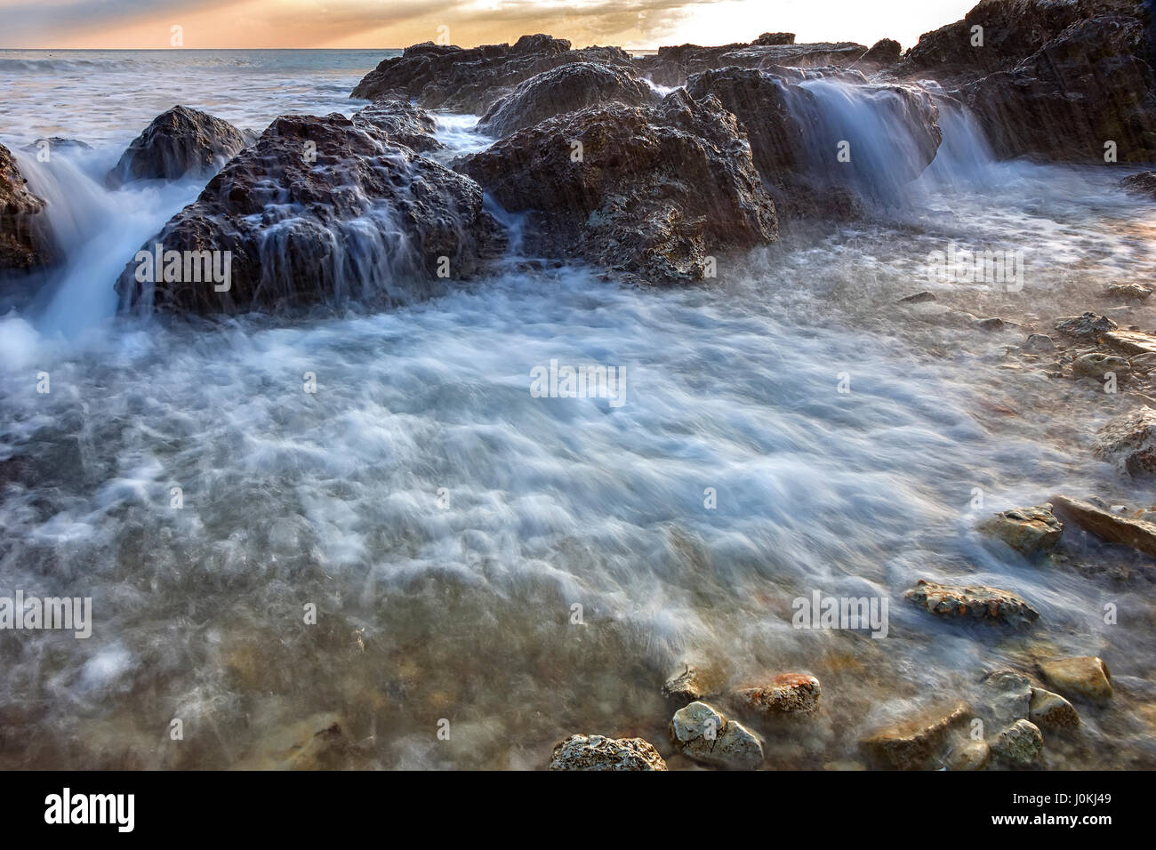 beauty close up flowing seawater over the rocks Stock Photo