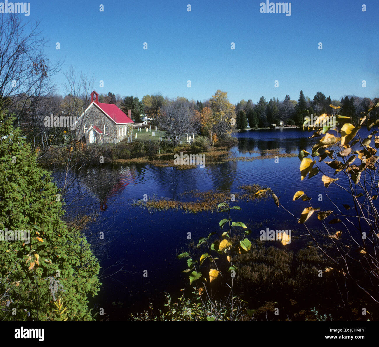 Stone church reflection in lake, Louisa, Quebec, Canada Stock Photo Alamy