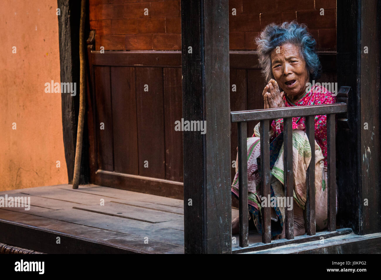 A smiling old lady in the old town of Kathmandu, Nepal Stock Photo