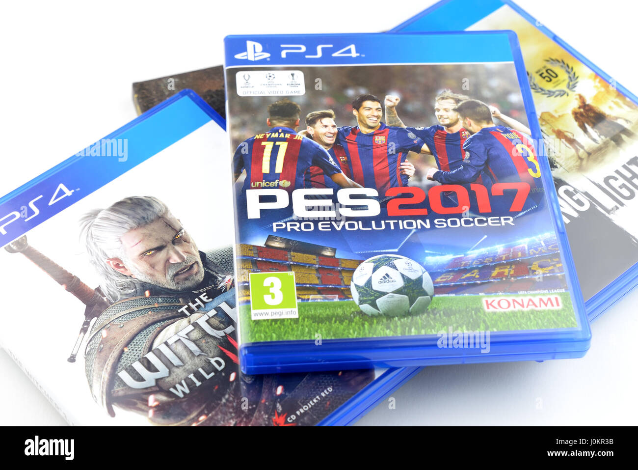 BARCELONA, SPAIN - JAN 24, 2017: A collection of video games for Playstation 4 devices, including Pro Evolution Soccer and The Witcher 3, isolated. Stock Photo
