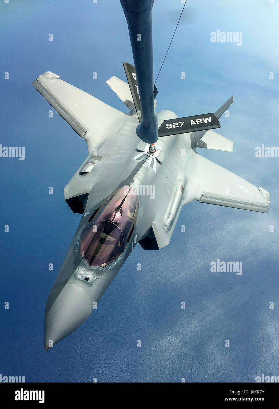 An F-35A Lightning II receives fuel from a KC-135 Stratotanker Stock Photo