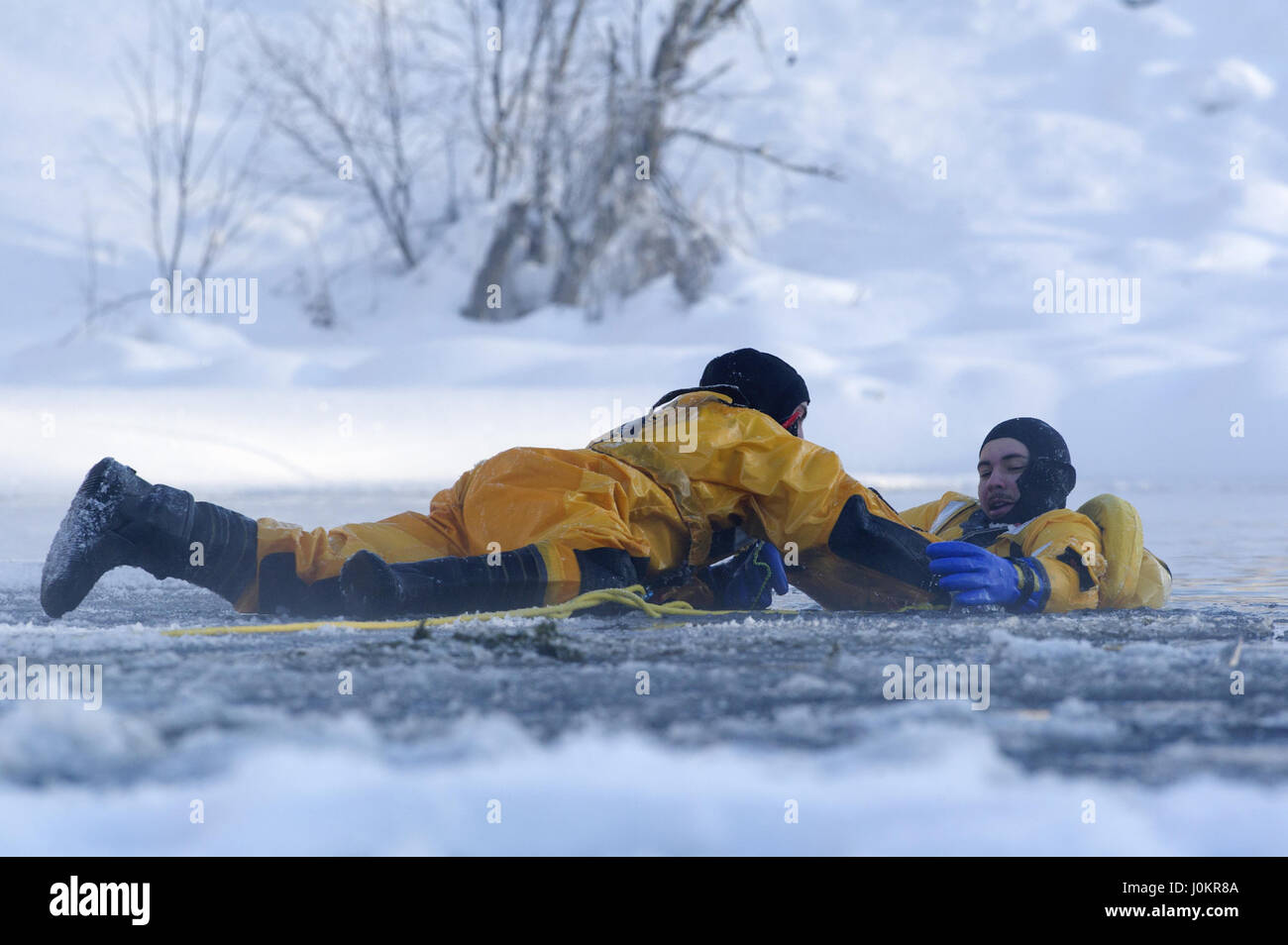 Air Force fire protection specialist, and Airman conduct ice water rescue training Stock Photo