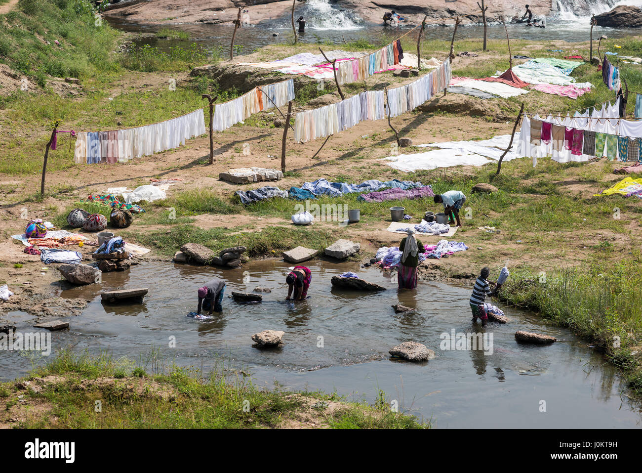 Women washing laundry in river, washing place, near Madurai, Tamil Nadu, India Stock Photo