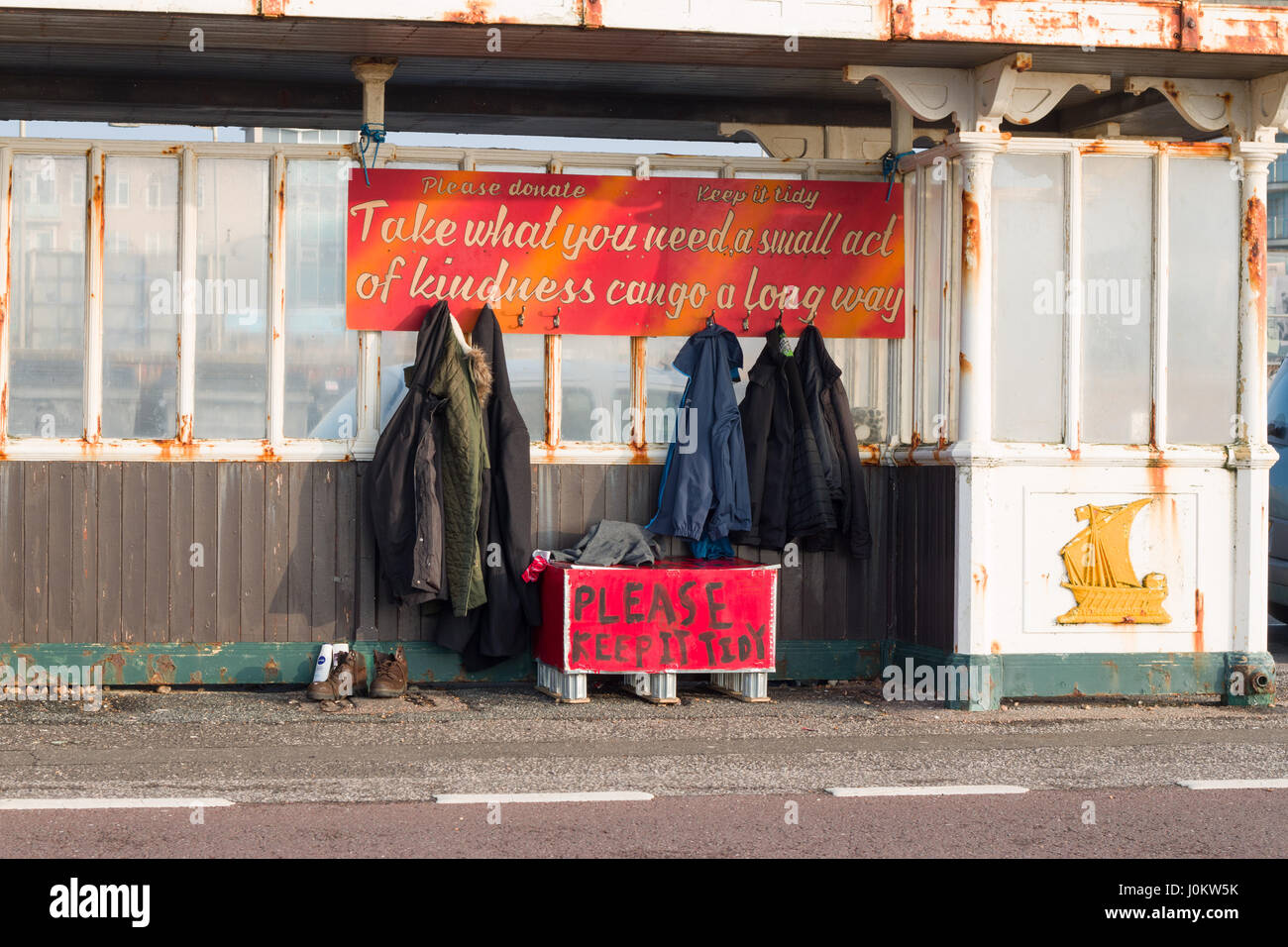 Seaside shelter on Hove promenade, with donated clothes free for homeless people to take. Stock Photo