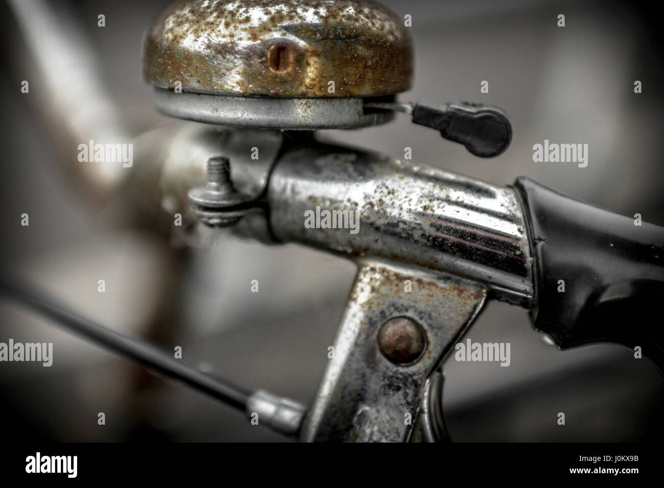 Old bicycle bell with rust. Close up image. Defocused blurry background. Stock Photo