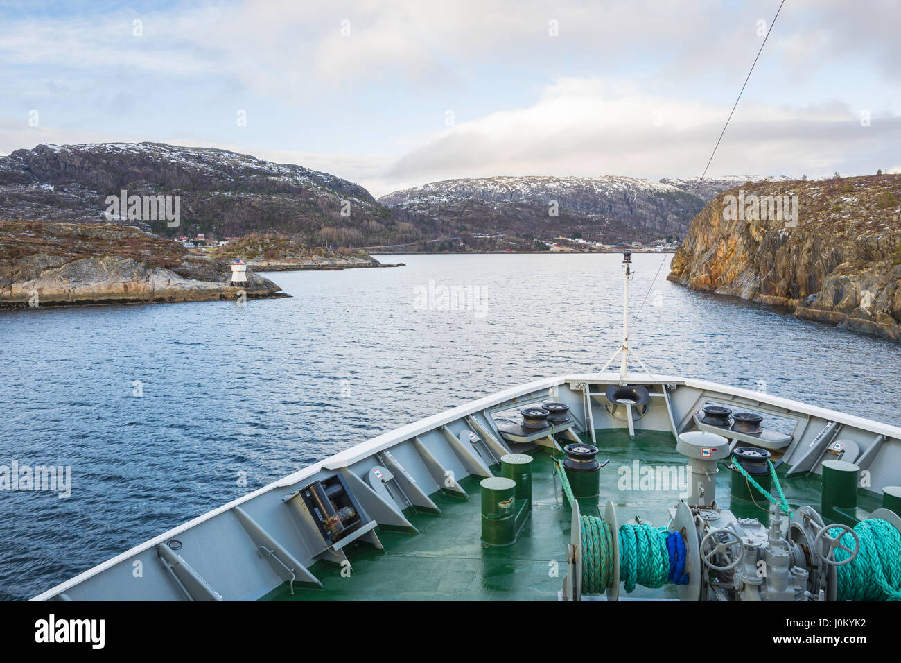 Hurtigruten ship, MS  Richard With, makes its way through the narrow strait of Stokksund, Norway.  Krokholmen to left, Brennholmen to right. Stock Photo