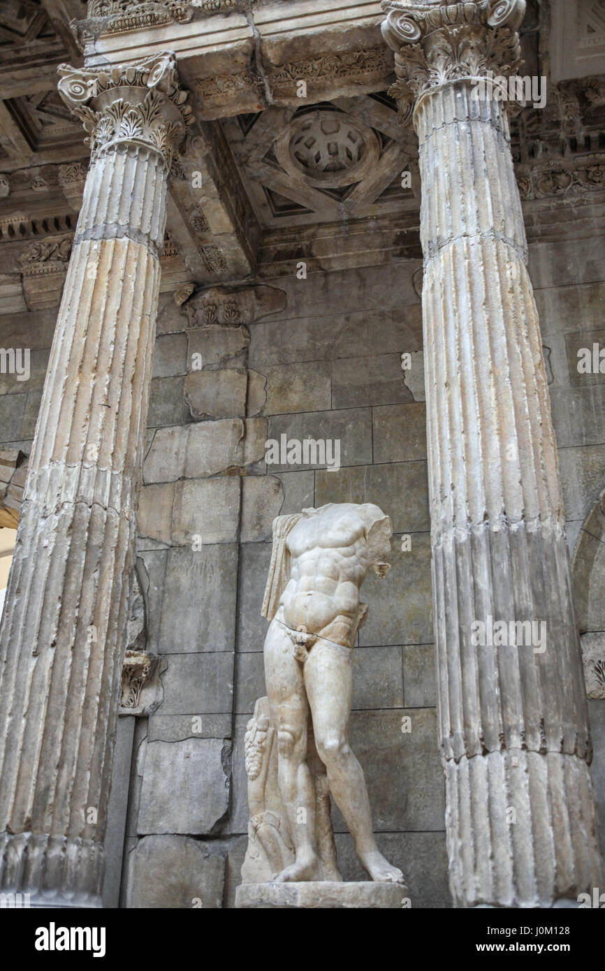 Beautiful greek statue of marble man without head between dorian columns Stock Photo