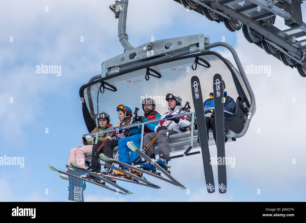 5 skiers on chairlifts, Chopok, Jasna, Slovakia Stock Photo