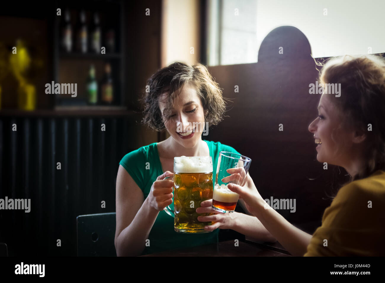 Brunette woman enjoying a glass of beer Stock Photo