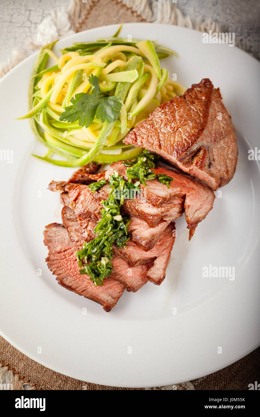 Zucchini pasta and meat. Grain effect added. Stock Photo