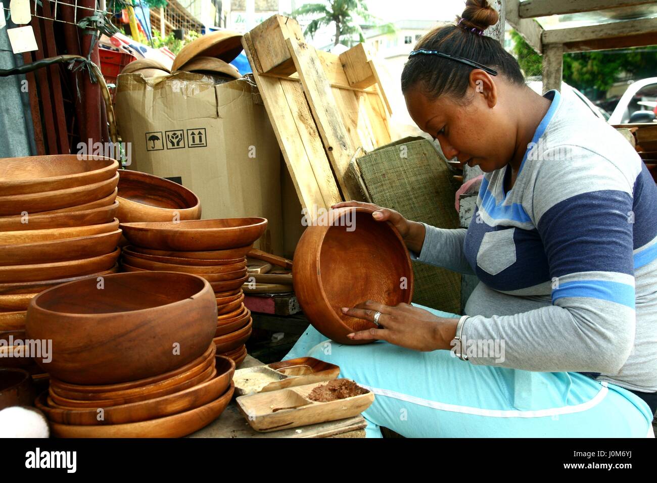 QUEZON CITY, PHILIPPINES JUNE 22, 2015 A handicraft maker apply