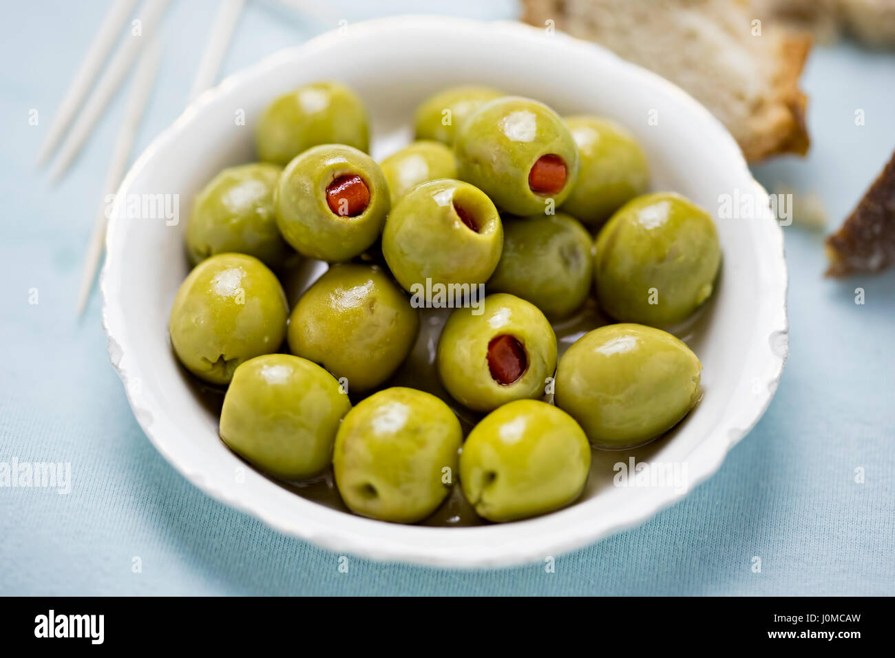Green olives stuffed red peppers Stock Photo