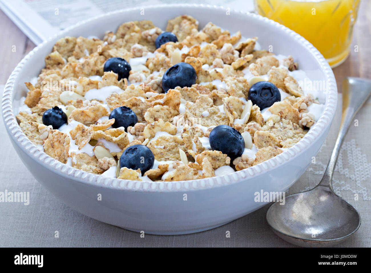 Cereals with milk, blueberries and orange juice Stock Photo Alamy