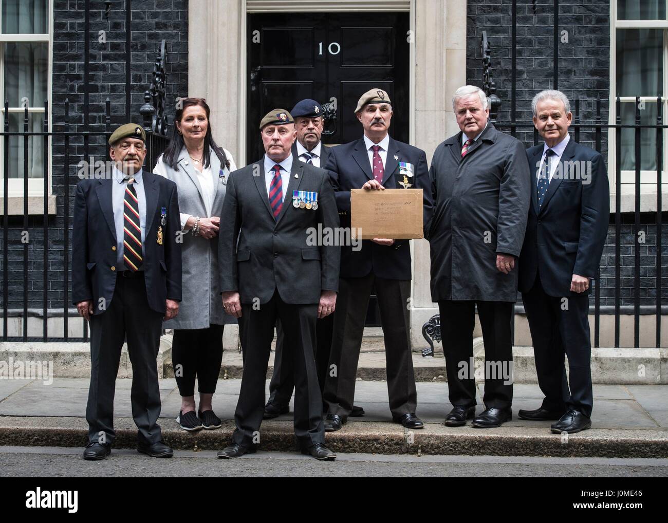 A letter is handed to Downing Street after a military veterans' rally in London, organised by Justice for Northern Ireland Veterans (JFNIV) which is seeking to highlight what it alleges is a legal witchhunt against former security members who served during the Troubles. Stock Photo