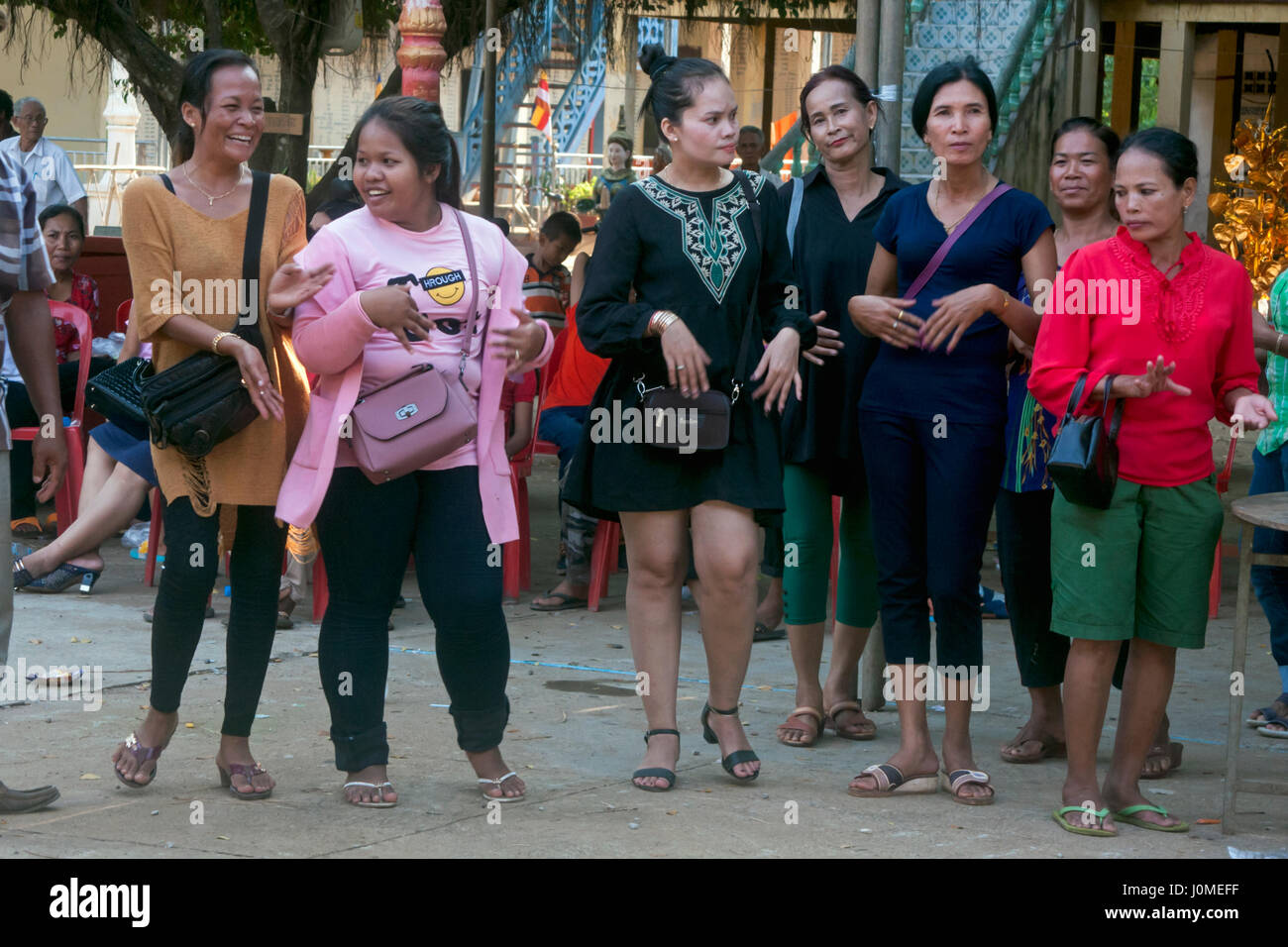 A group of Cambodian women are dancing during a traditional Khmer New Year celebration at a pagoda in Chork Village, Khmum Tboung Province, Cambodia. Stock Photo