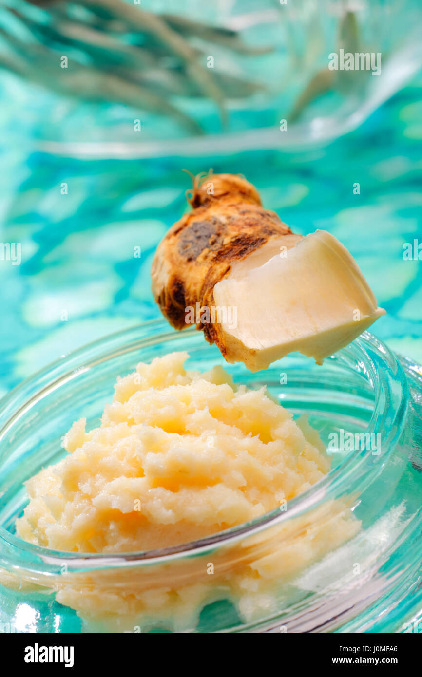 Piece and grated horseradish with unfocused background Stock Photo Alamy