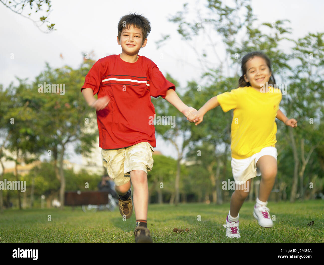 Two girls holding hands running hi-res stock photography and images - Alamy