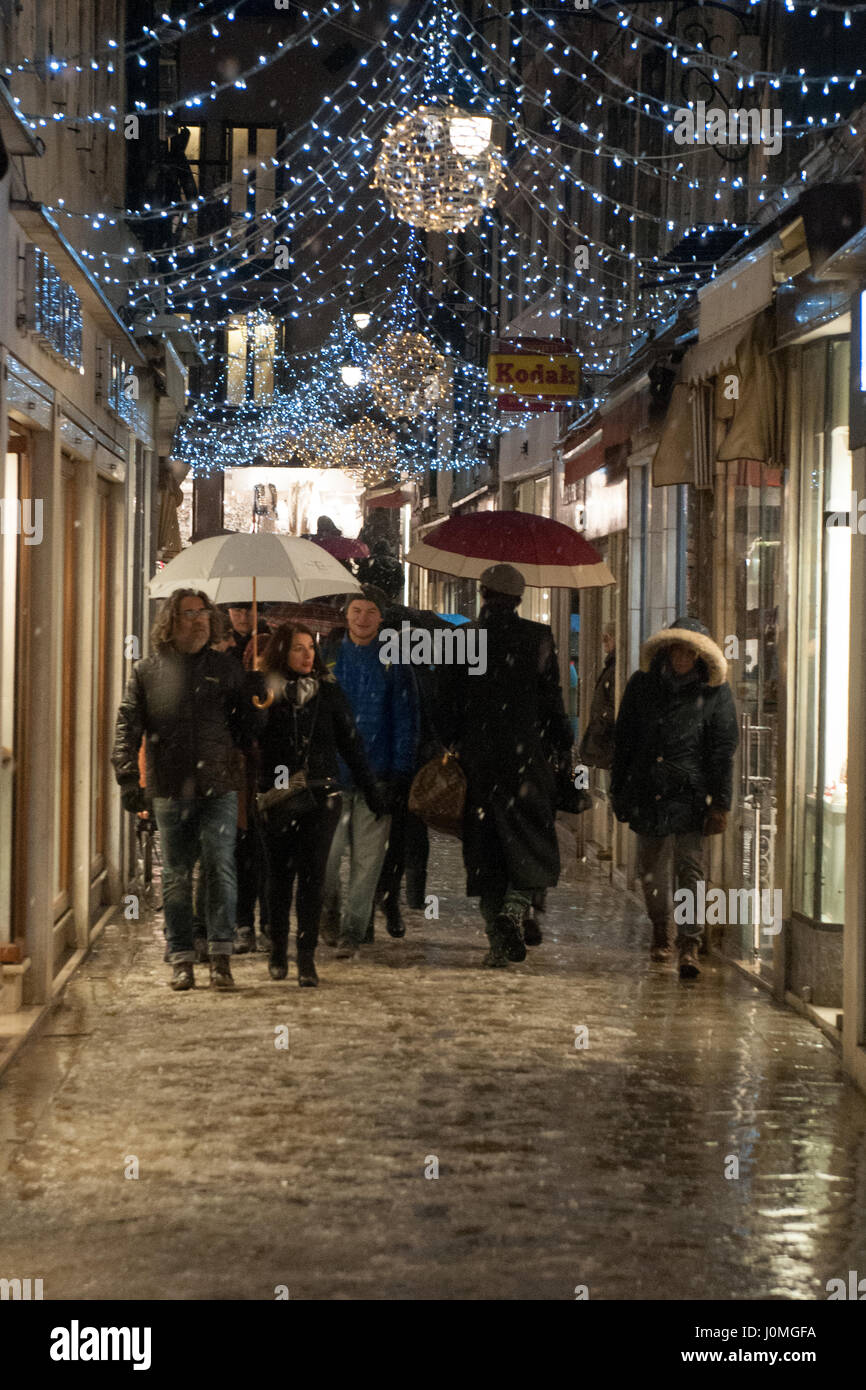 People walk in a street during an heavy snow fall in Venice. Stock Photo