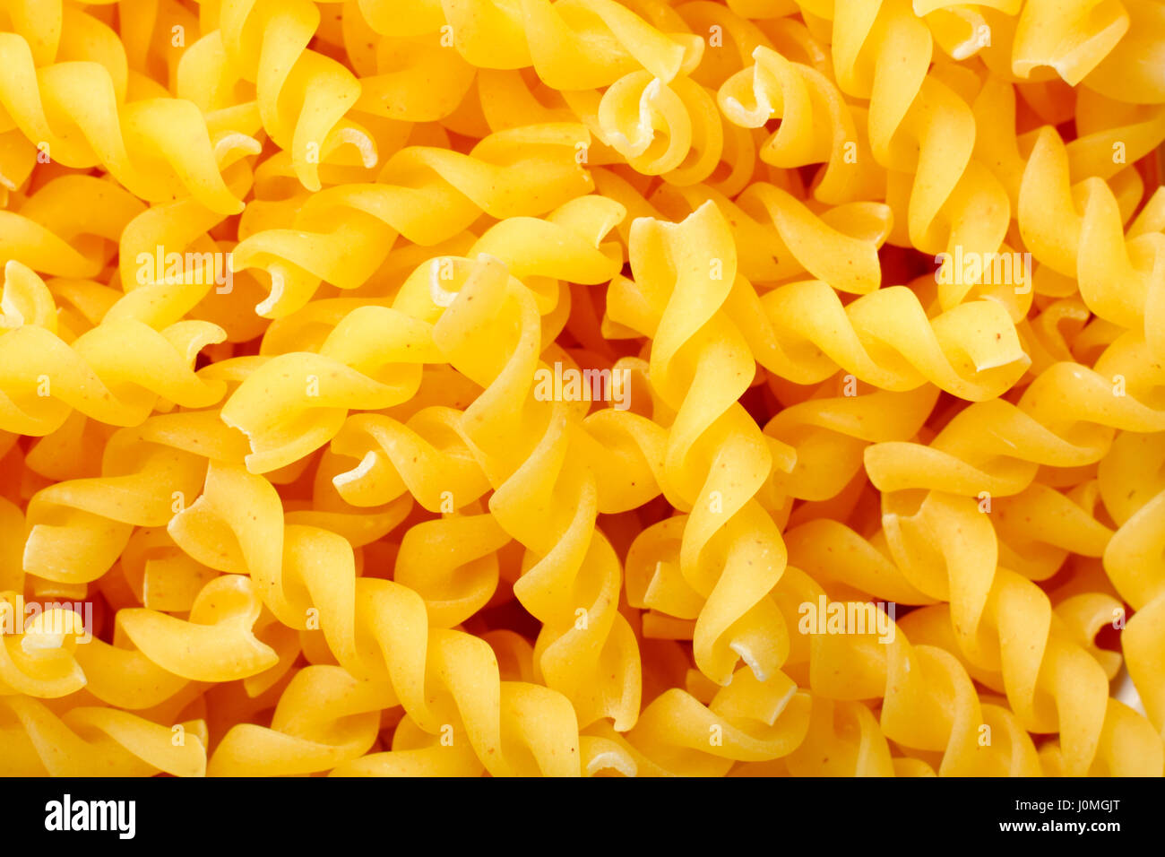 Raw rotini pasta. Full frame, top view Stock Photo Alamy