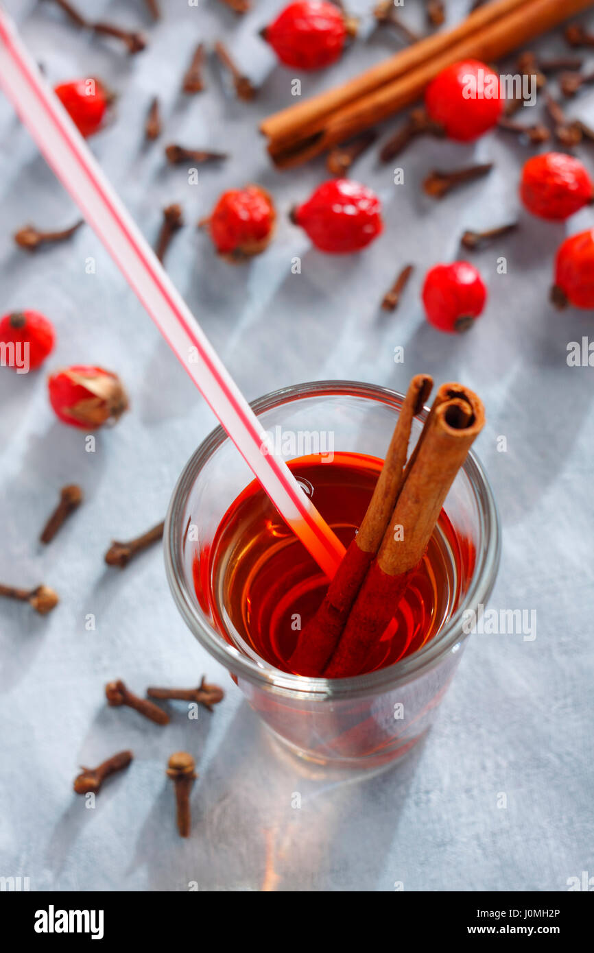 Red drink with a cinnamon stick and a drinking straw Stock Photo