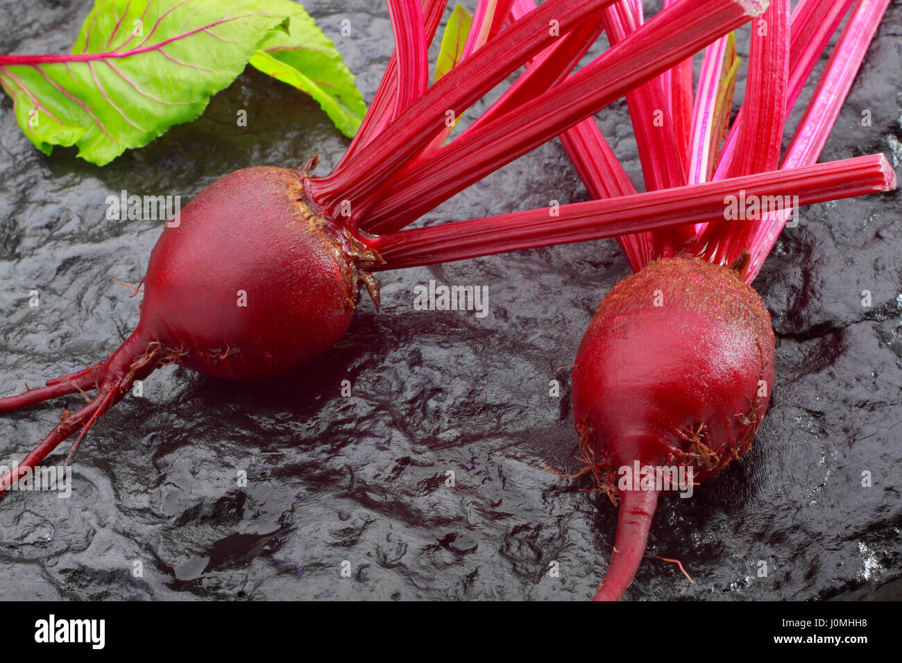Fresh red beetroot on black painted stone Stock Photo