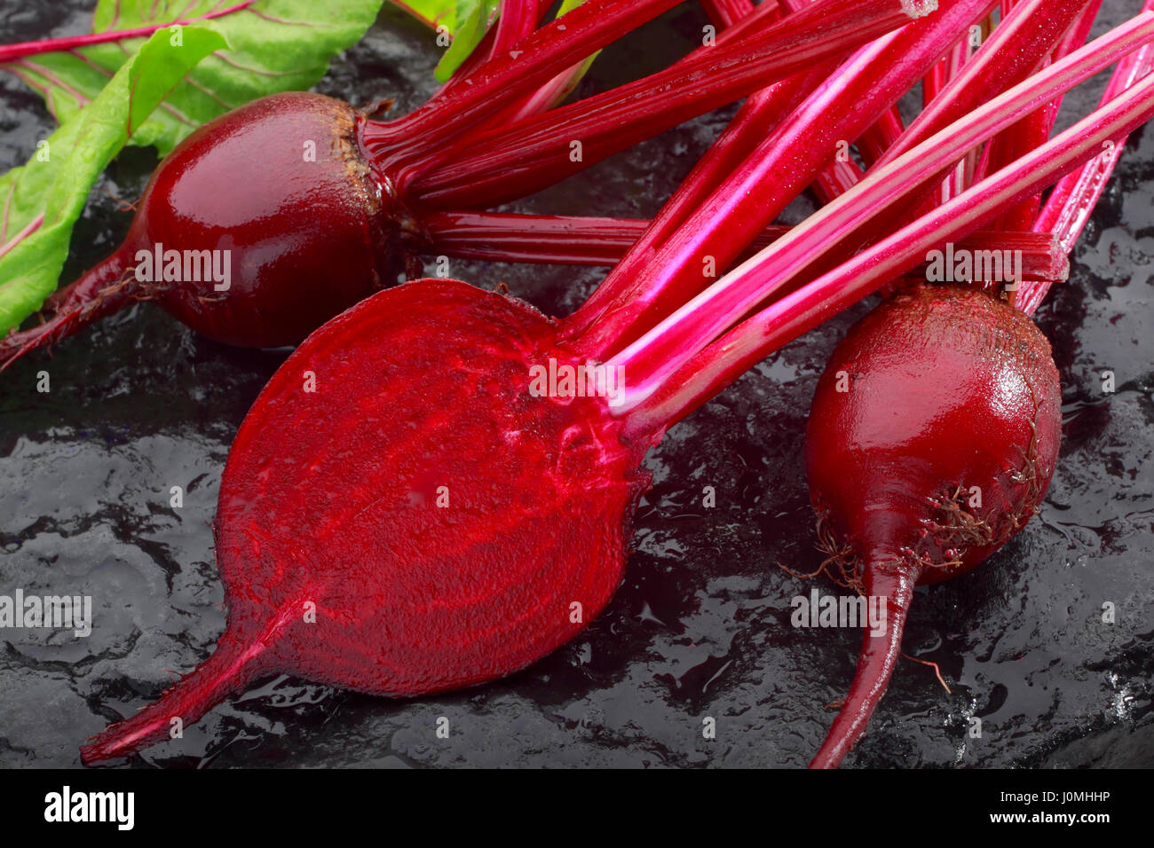 Fresh red beetroot on black painted stone Stock Photo