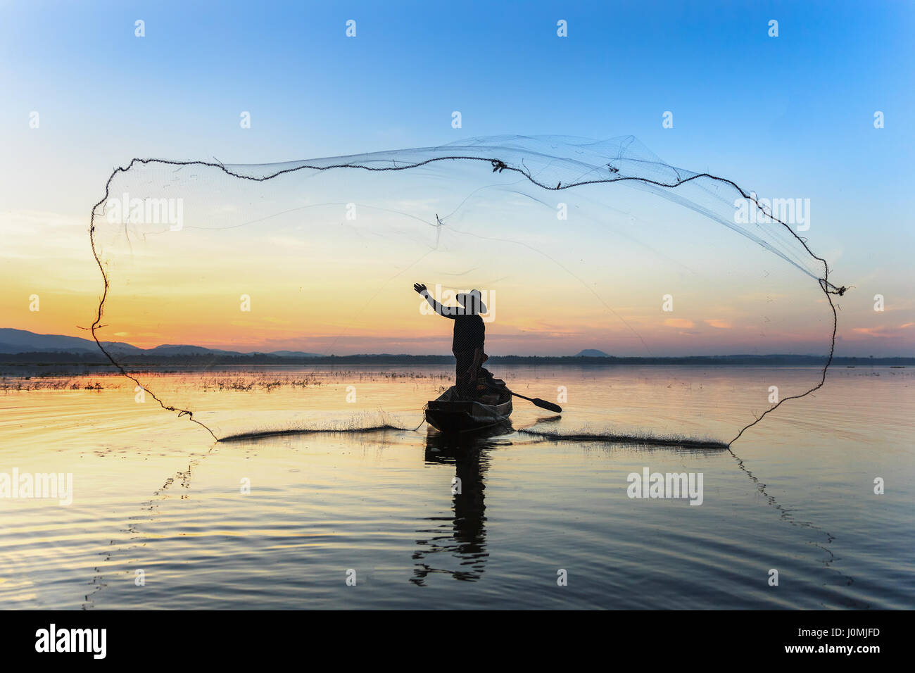 Fisherman casting fishing net at sunset hi-res stock photography and images  - Alamy