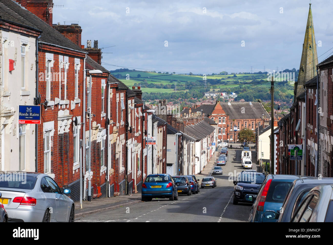 Terraced houses on the steeply sloping road of Lower Mayer Street in