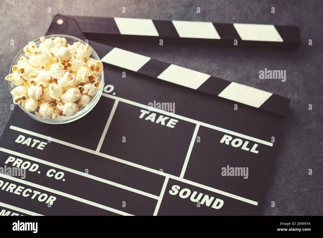 popcorn and movie maker on black table background Stock Photo - Alamy