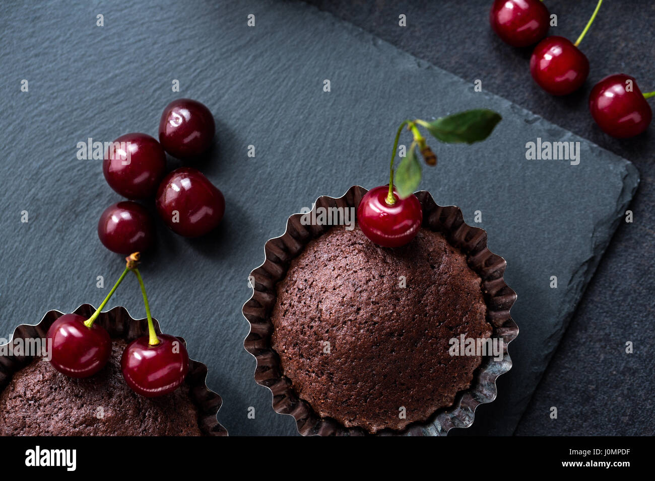 Chocolate muffins with cherry close up Stock Photo - Alamy