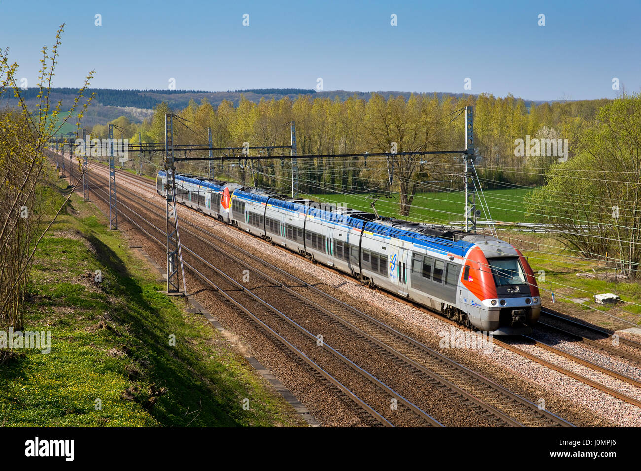Passenger train SNCF ( AGC Bombardier ) crossing Burgundy, France Stock Photo