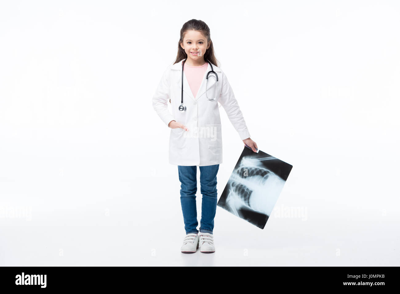 Full length portrait of little girl in medical uniform holding x-ray ...