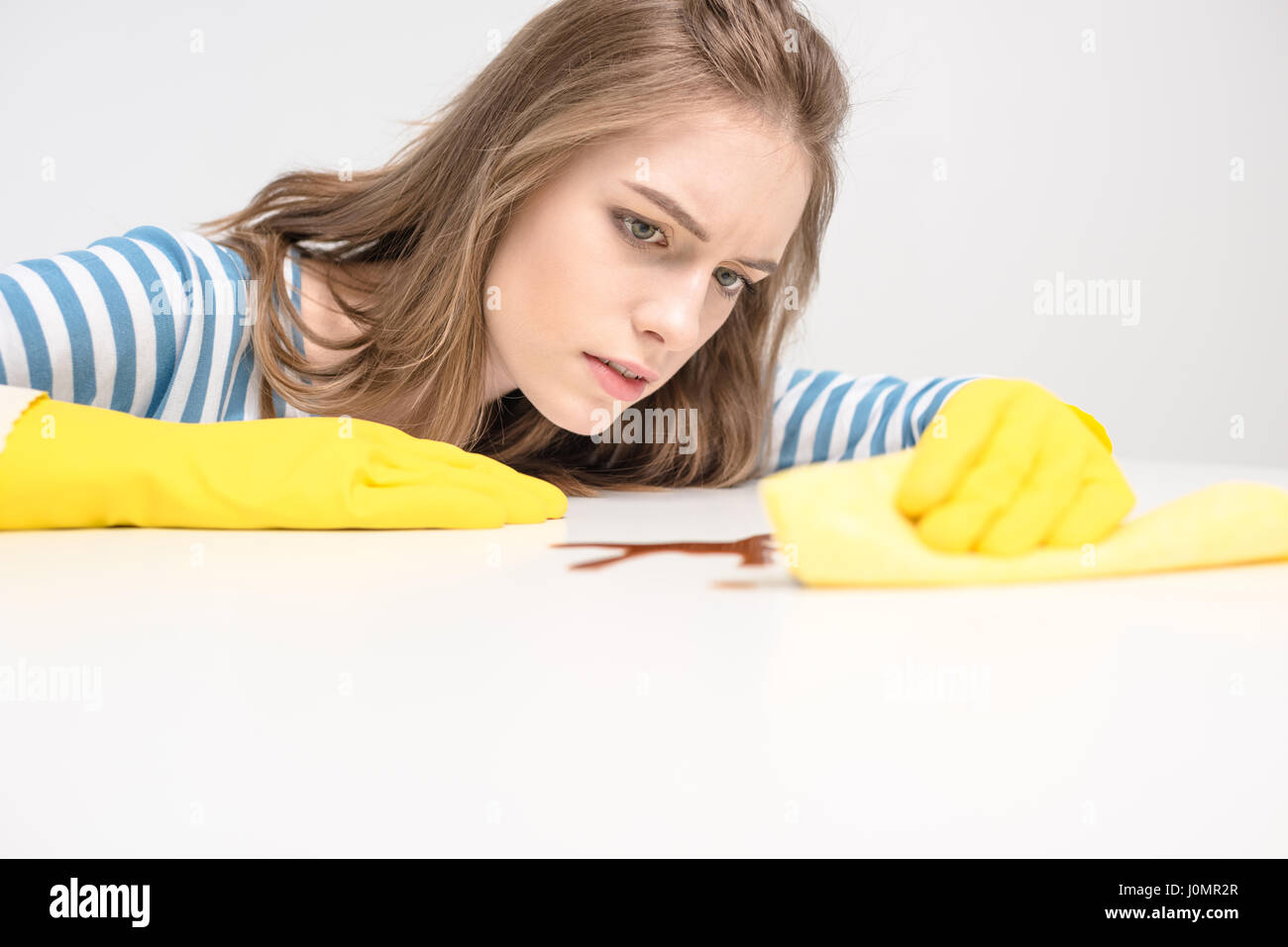 Young woman in yellow rubber gloves removing stain with rag Stock Photo ...