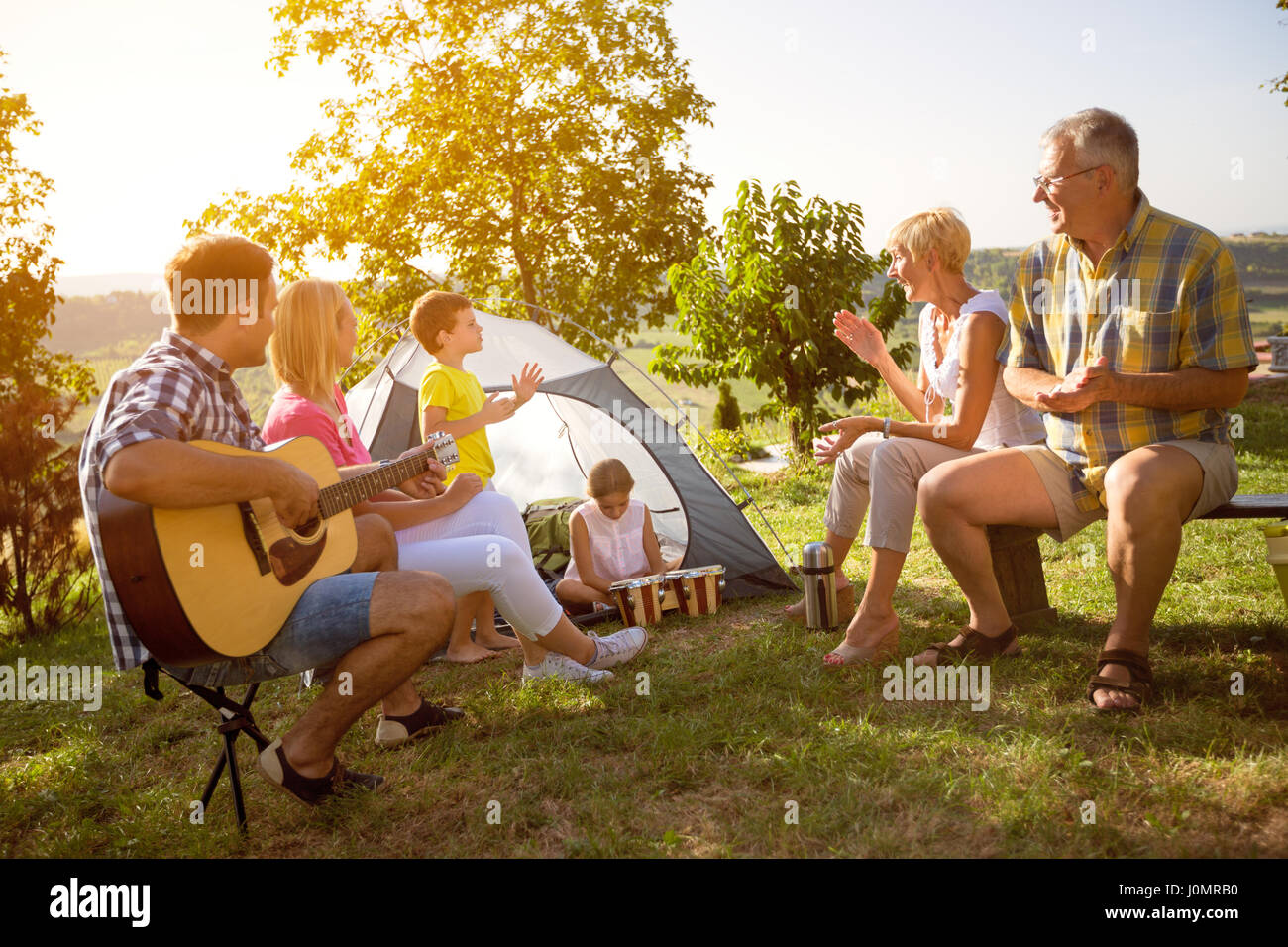 Family enjoying camping holiday in countryside Stock Photo