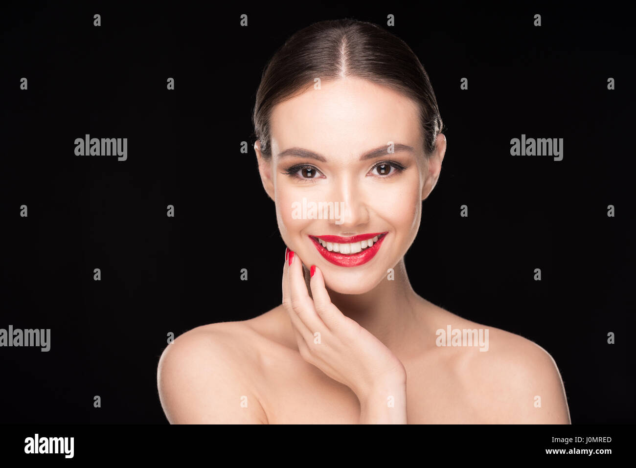 Portrait of pretty young brunette woman with red lips smiling at camera Stock Photo