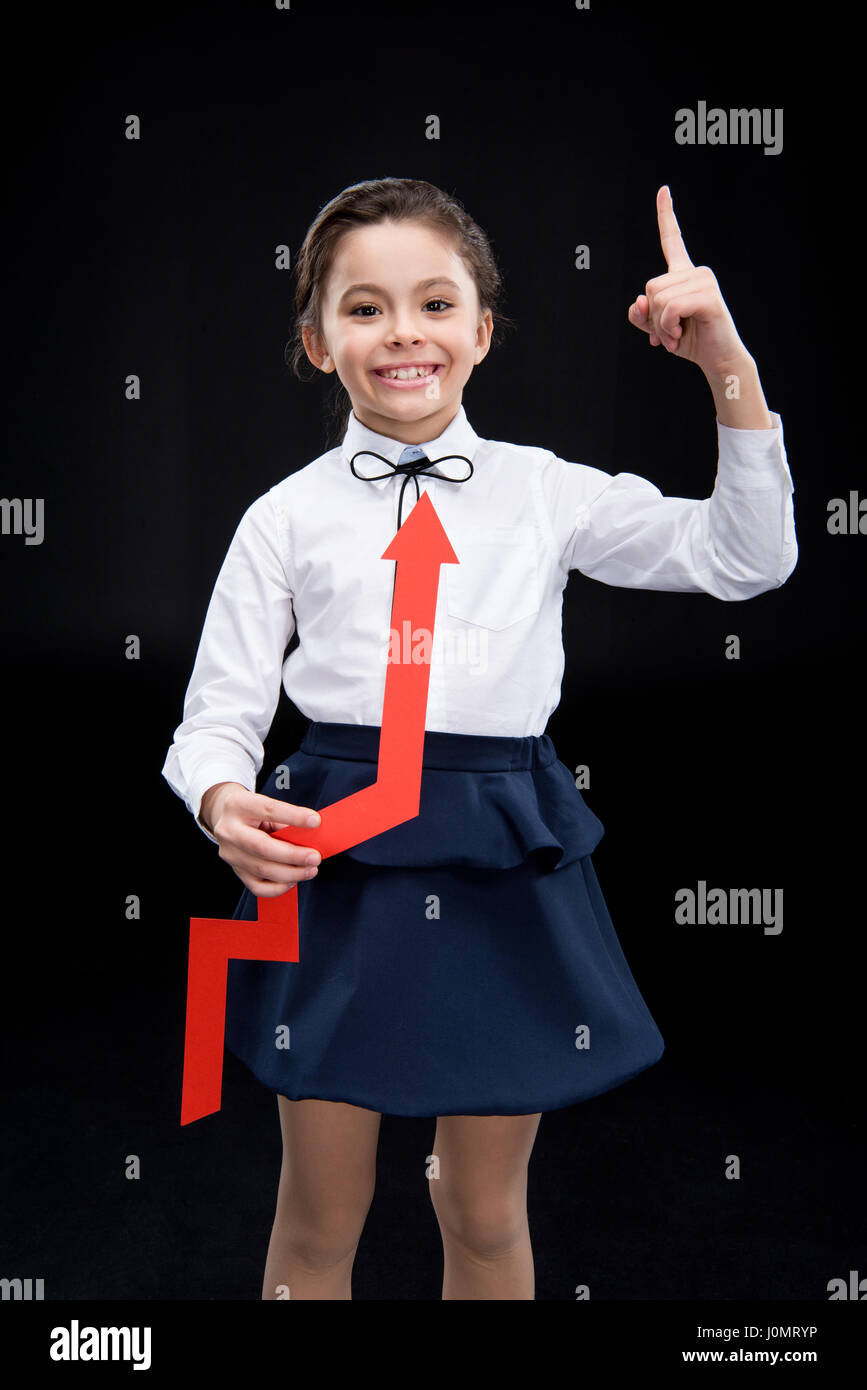 Girl with red arrow pointing up on black Stock Photo - Alamy