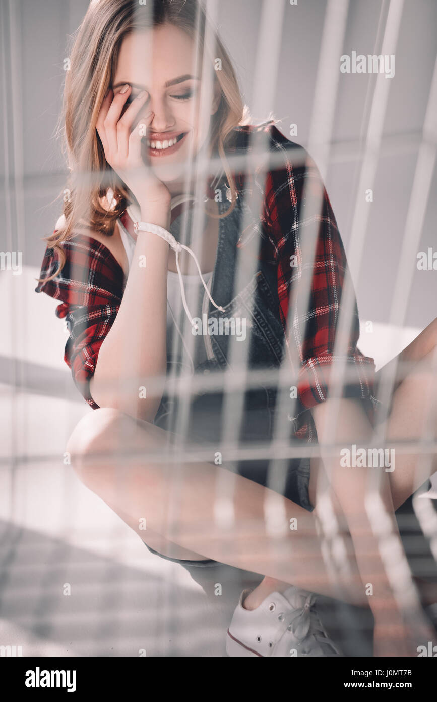 Attractive young woman with closed eyes sitting and smiling Stock Photo ...